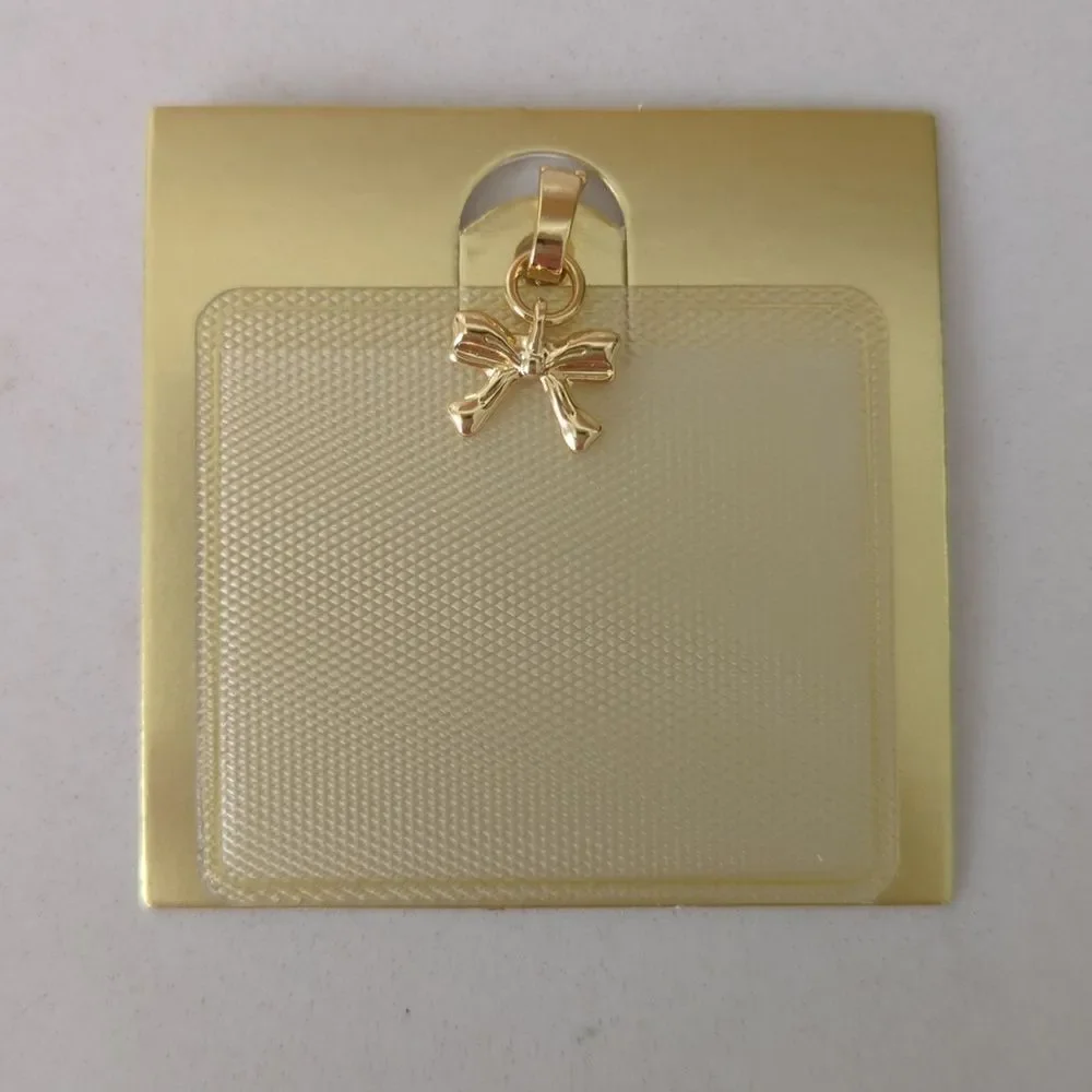Gold bow charm